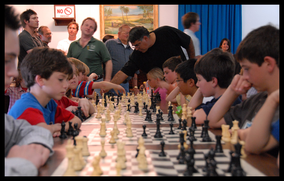 Kids playing chess with a clock and keeping score